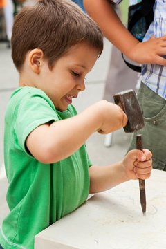  Child sculptor with chisel