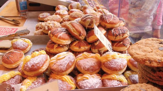 Display of a variety of doughnuts at a market stall