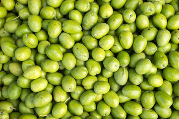 Many fresh green raw olives at the market