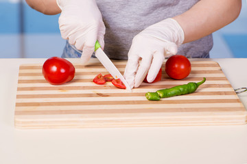 Hands of cook preparing salad