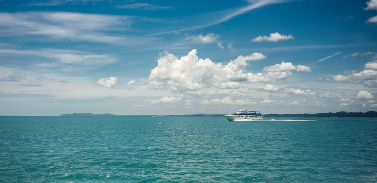 Wite ferry in the sea. Cloudy sky. Malaysia. Mersing - Tioman