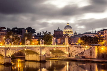 Fototapeta na wymiar Rome and Vatican, cityscape at night, with St peter's basilica and bridge over the river Tiber