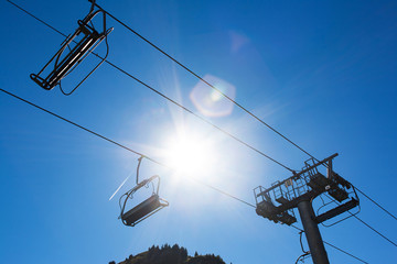 Chairlift against sun