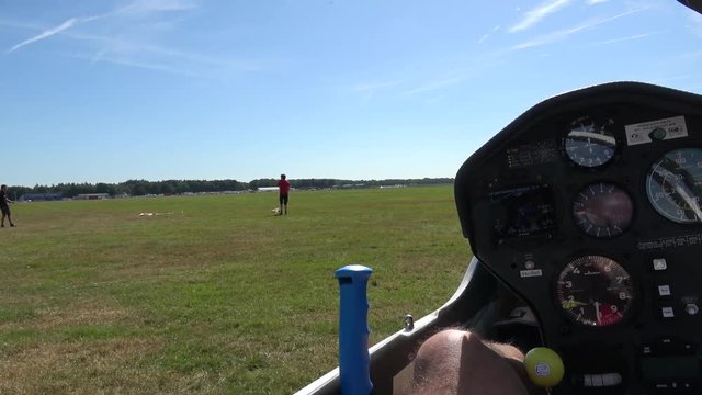 Cockpit point of view POV footage in modern glider sailplane waiting for takeoff guys preparing tow cables showing also gauges for reading altitude airspeed ascending speed beautiful day blue sky 4k