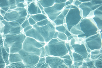 Fototapeta na wymiar Detal of swimming pool water and sun reflecting on the surface