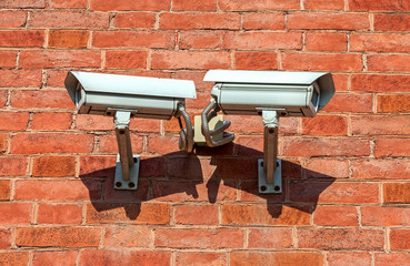 Surveillance cameras mounted on the wall of the building