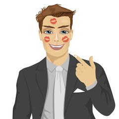 young happy businessman showing red lipstick kiss marks on face