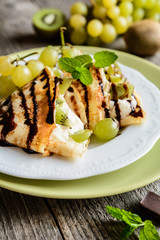 Pancakes with mascarpone filling, kiwi, grape and chocolate topping