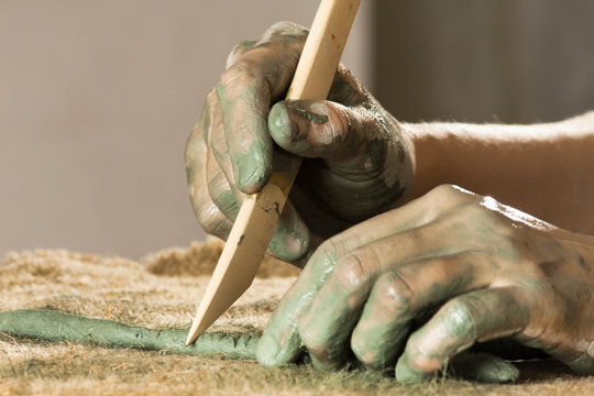 Hands Working With Blue Clay