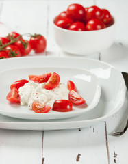 Cherry Tomatoes, Soft Cottage Cheese. White Table.