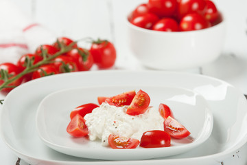 Cherry Tomatoes, Soft Cottage Cheese. White Table.