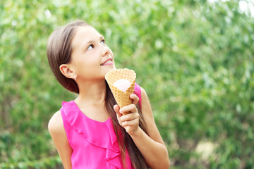 Portrait of  little girl with ice-cream in the park