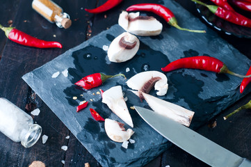 Sliced mushrooms on board.