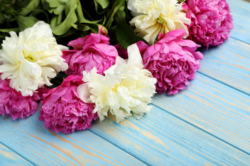 Bouquet of peony flowers on wooden table