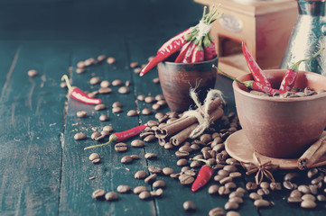 Coffee beans and red chilly peppers. Tonned photo