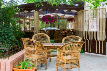 Summer cafe with the straws chairs and a table
