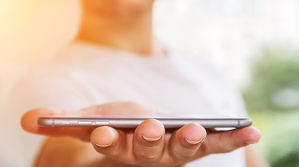 Businessman holding modern mobile phone