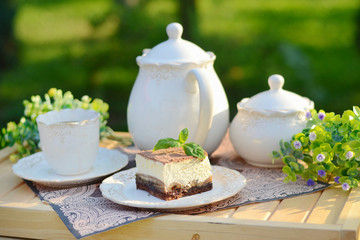 Image of a cup of coffee with a piece of cake
