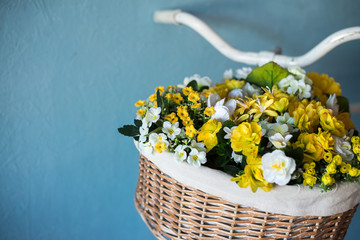 Fototapeta na wymiar old bicycle with flowers on blue background