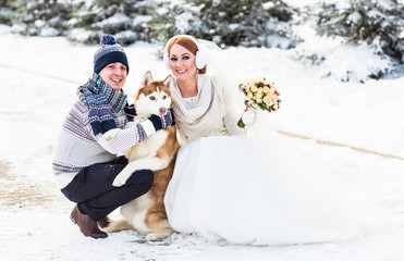 Fototapeta na wymiar Bride and groom wedding with dog winter outdoor.