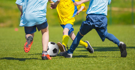 Training and football match between youth soccer teams. Young boys playing soccer game. Hard competition between players running and kicking soccer ball. Final game of football tournament for kids