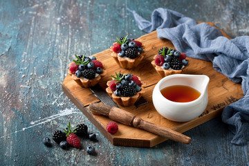 Walnut tartlets with custard and berries, selective focus