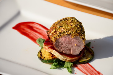 Roasted pork tenderloin with walnut and peppercorn crust.