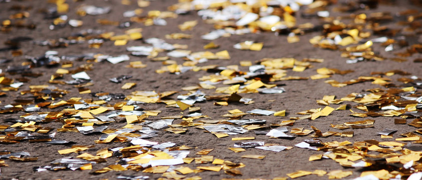 festival background with gold and silver sequins that lie on the pavement the road bokeh.