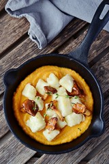 Gnocchi with pumpkin sauce and chanterelles mushrooms, top view
