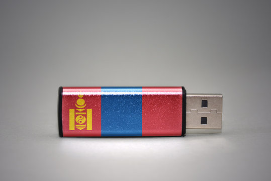 usb flash drive with the national flag of mongolia on gray background.