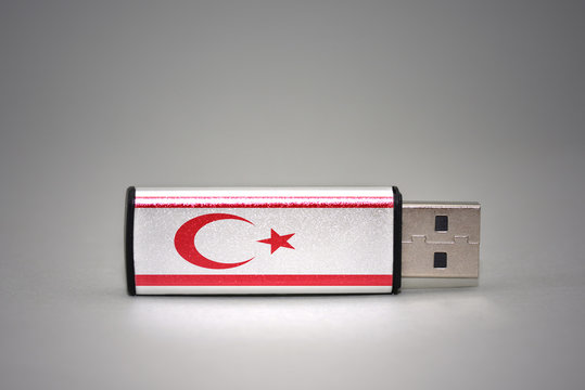 usb flash drive with the national flag of northern cyprus on gray background.