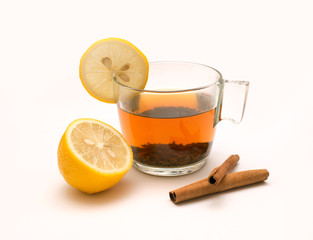 Tea in glass mug, lemons and spices, cinnamon, anise