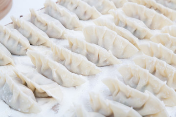 raw dumplings on the wooden desk