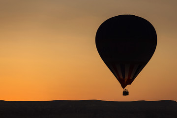 Silhouette of balloon over sunrise in Cappadocia, Turkye