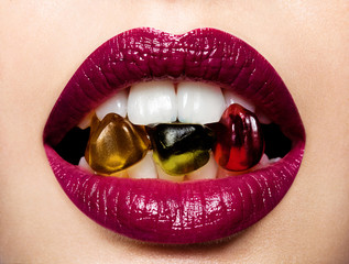 Beautiful female lips with multicolored gummi bears