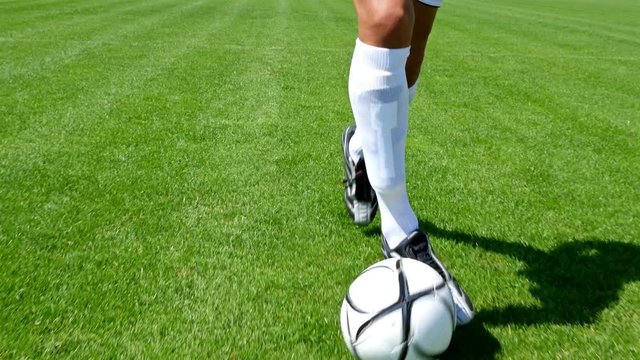 Footballer making tricks to avoid the defender