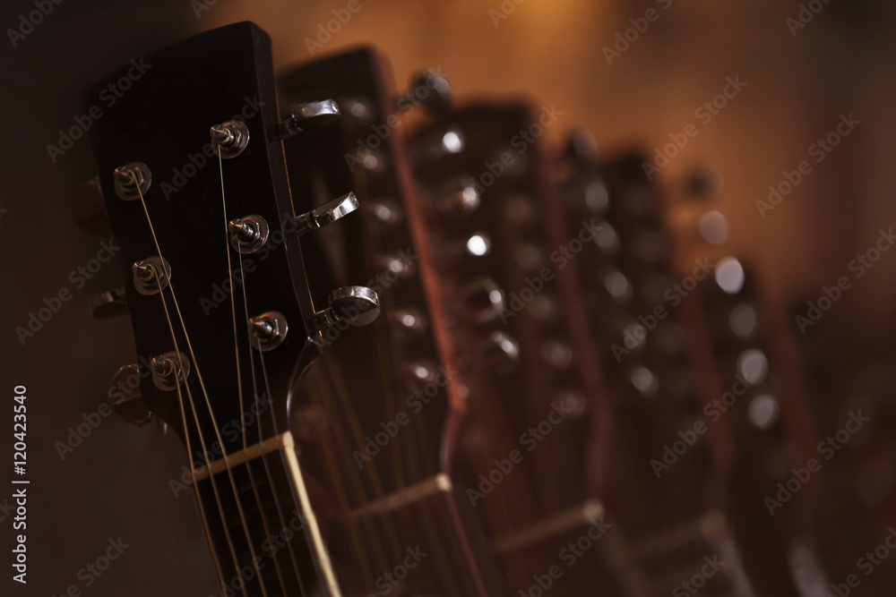 Wall mural Guitars hanging on wall, closeup