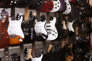Obraz na płótnie Canvas Guitars hanging on wall, closeup