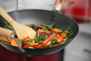 Mixing vegetables in pan closeup