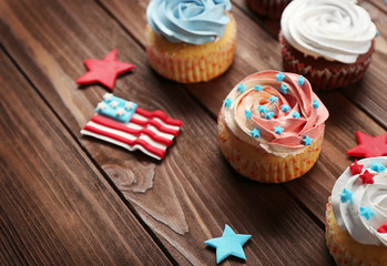 Delicious cupcakes on wooden background