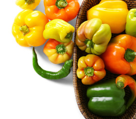 Basket with fresh peppers on white background