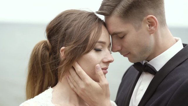 Bridegroom Holding Gently Hand on Bride's Face