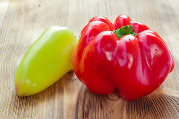 Vegetable still life of two mature red and green peppers