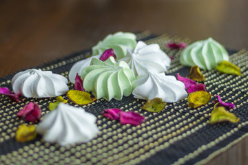 White and green marshmallow sweet dessert composition on black b