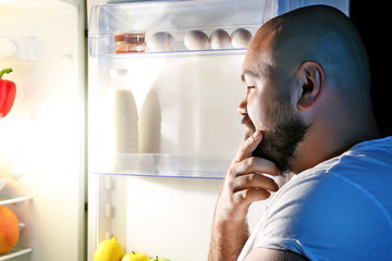 Man taking food from refrigerator