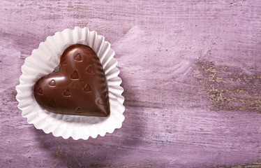 Chocolate heart on a wooden background