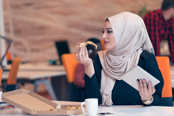 Young Arabic business woman wearing hijab,working in her startup office. Diversity, multiracial concept.
