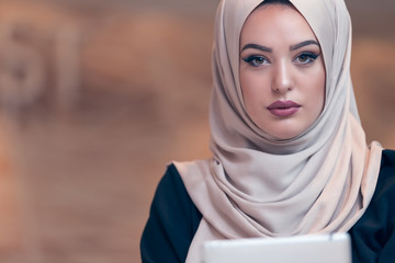 Young Arabic business woman wearing hijab,working in her startup office. Diversity, multiracial...