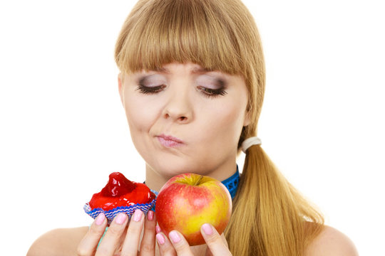 Woman choosing fruit or cake make dietary choice