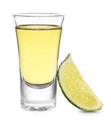 Fototapeta na wymiar Shot of gold tequila with lime slice isolated on white